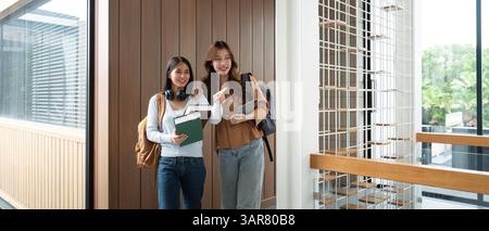 University Friendship and Study Sessions. Two female students enjoying each other's company while studying together. Stock Photo