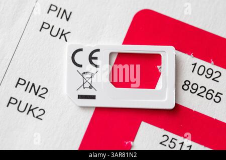 Bavaria, Germany - April 16, 2025: PIN and PUK codes on a carrier card of a mobile phone provider - important access data for unlocking blocked SIM cards and managing mobile devices. *** PIN- und PUK-Codes auf einer Trägerkarte eines Mobilfunkanbieters wichtige Zugangsdaten für die Entsperrung gesperrter SIM-Karten und Verwaltung mobiler Endgeräte. Stock Photo