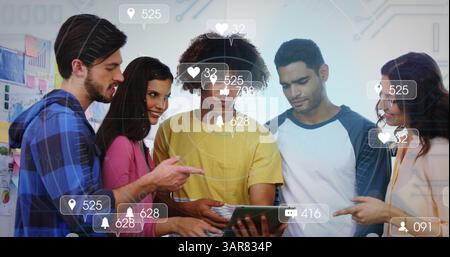 Image of social media icons and numbers over diverse students using tablet Stock Photo