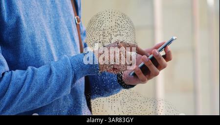 Image of rotating digital head over hands of caucasian man using smartphone Stock Photo