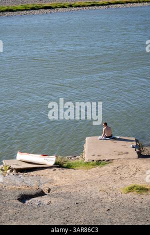 Norotshama Resort,  Man Sitting on Orange River Bank  in Namibia Stock Photo