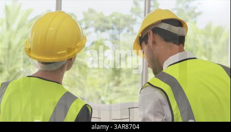 Image of statistics processing over male and female architects talking at construction site Stock Photo