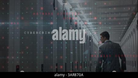 Image of cyberattack over caucasian man in server room Stock Photo