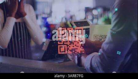 Neon qr code against african american man making digital payment from his smartphone at a cafe Stock Photo