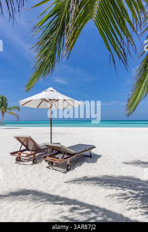 Chairs umbrella romantic honeymoon beach, romantic for summer vacation, relaxing ocean with stunning views, sunny skies, and tropical getaway Stock Photo
