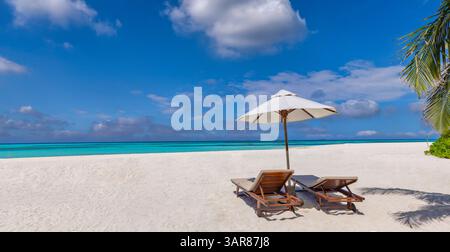 Chairs umbrella romantic honeymoon beach, romantic for summer vacation, relaxing ocean with stunning views, sunny skies, and tropical getaway Stock Photo