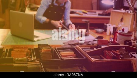 Image of caucasian female worker using laptop repairing in workshop Stock Photo