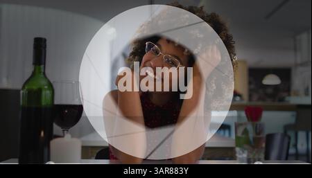 Image of circle over happy biracial woman with wine having image call Stock Photo