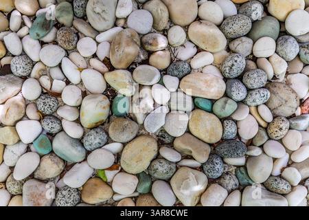 Top view of smooth pebbles in natural tones aesthetic stone textures perfect for backgrounds, nature lovers, spa vibes, serene minimalist inspiration Stock Photo