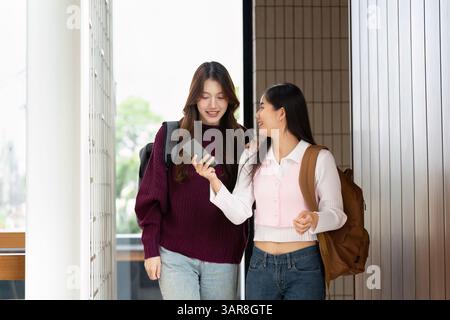 Collaboration and Learning. Two students share insights while walking in a college environment. Stock Photo