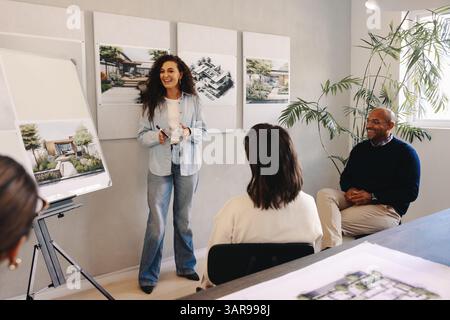 A team collaborates on strategic planning, using visual aids to enhance project discussions in an office setting. The ambiance reflects professionalis Stock Photo