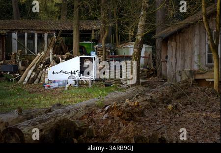propped up bicycle caravan during a rest in front of a wooden cabin Stock Photo