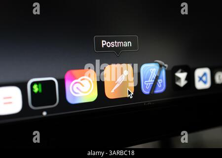 Poznan, Poland – April 14, 2025: Close-up of Postman icon in macOS dock, widely used by developers for API design, testing, automation and team collab Stock Photo