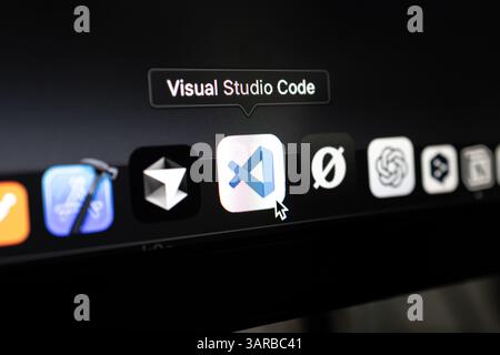 Poznan, Poland – April 14, 2025: Close-up of Visual Studio Code icon selected in the macOS dock, widely used cross-platform source-code editor for pro Stock Photo