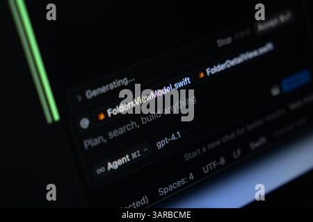 Poznan, Poland – April 14, 2025: Close-up of Cursor editor running GPT-4 integration while generating Swift code in a file named FoldersViewModel.swif Stock Photo