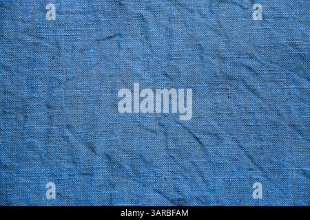 Blue crumpled linen fabric texture detail closeup as textile background Stock Photo