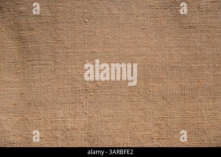 Earth brown linen fabric texture detail closeup as textile background Stock Photo