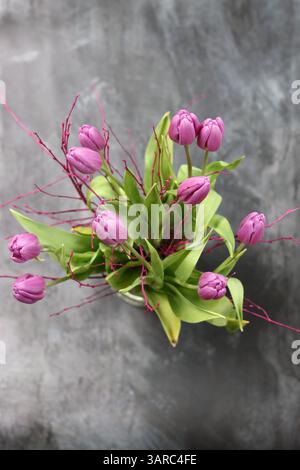 Beautiful violet tulip flowers. Bouquet of tulips on grey background with copy space. Stock Photo