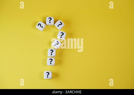 Question mark shape and symbol formed by many questions sign on white dices. Customer questions, faqs and business assistance concept top view. Stock Photo