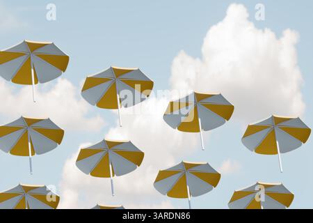 Bright umbrellas float against a blue sky, creating a whimsical summer scene. 3d rendering Stock Photo