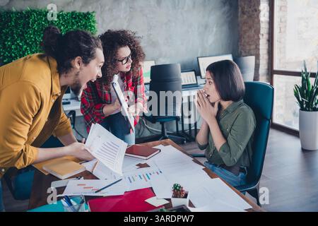 Diverse group of colleagues having a discussion in a modern office setting, focusing on teamwork and collaboration Stock Photo