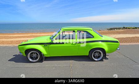 Classic 1972 MK1 Ford Escort Mexico YB Turbo parked on seafront beach and sea in background. Stock Photo