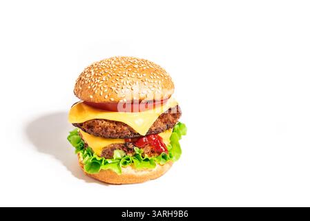 Double cheeseburger with lettuce, tomato, ketchup and melted american cheese isolated on white background. Big ultimate beef burger with extra meat. H Stock Photo