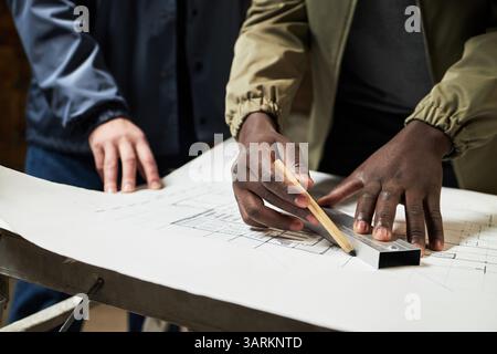 Medium close up of unrecognizable male hands using pen and Stock Photo