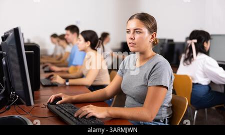 Woman learning to use software in computer class Stock Photo
