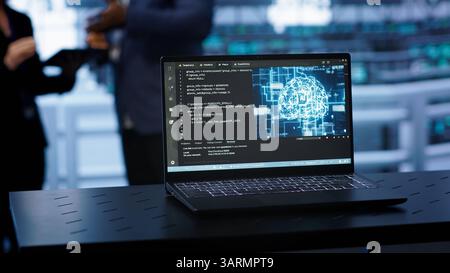 Laptop in data center establishment with artificial intelligence computing simulating human brain. Close up shot of notebook displaying AI machine learning algorithms, camera A Stock Photo