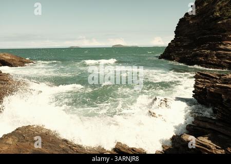 Waves hitting rocks in Buzios, Brazil Stock Photo