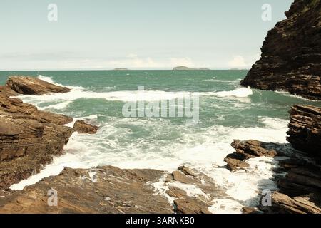 Waves hitting rocks in Buzios, Brazil Stock Photo