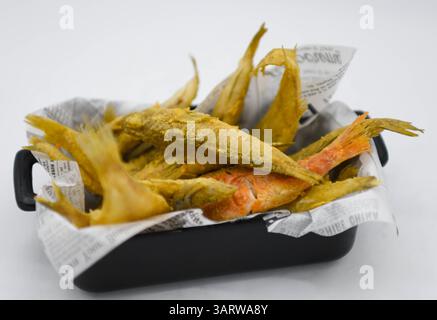 Fried fish in a box on a white background, close-up Stock Photo