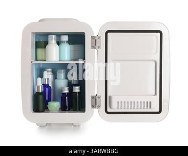 Small cosmetic refrigerator with cosmetic products on white background Stock Photo