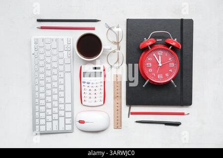 Composition with different stationery, modern gadgets, cup of coffee and alarm clock on light background Stock Photo