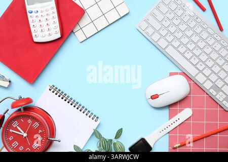 Frame made of different stationery, modern gadgets and alarm clock on color background Stock Photo