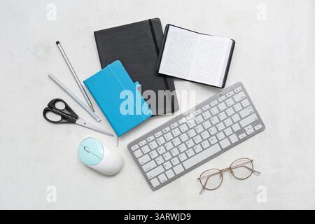 Composition with modern gadgets, stationery and eyeglasses on light background Stock Photo