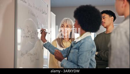 Teacher, lesson and student writing on whiteboard for math solution, education support and equation answer. Educator, people and learning at high Stock Photo
