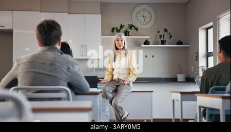 Education, teacher and talking to students, classroom and plants for environmental science in high school. Knowledge, educator and explaining biology Stock Photo