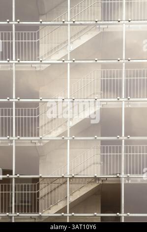 Architectural detail of a modern building featuring an external staircase behind a glass facade Stock Photo