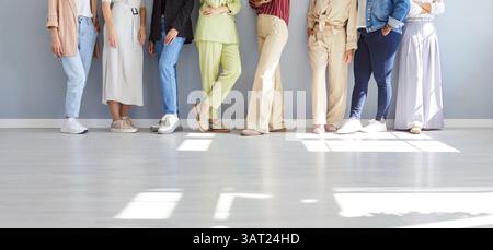 Midsection Shot Of Female Business Team During Meeting On Gray Background Stock Photo