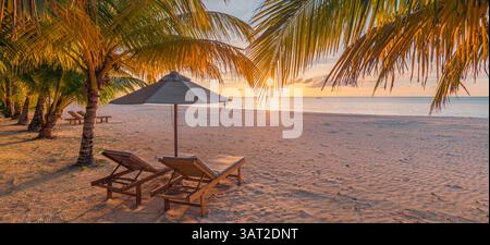 Panoramic sunset sea sky beach shore chairs umbrella, perfect luxury lifestyle honeymoon destination for love couples seeking romantic summer vacation Stock Photo