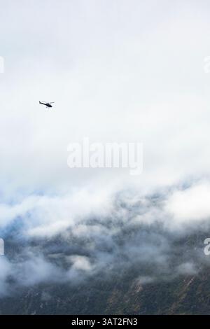 Helicopter over Milford Sound, New Zealand Stock Photo
