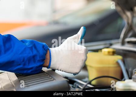 Cropped image of mechanic working in auto service.Showing Ok sign Stock Photo