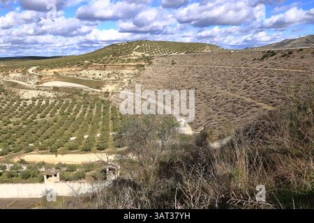 Concrete spillway in a loose material dam under a blue sky in south of Spain. Vadomojon dam. Embankment dam. rock-filled dam Stock Photo