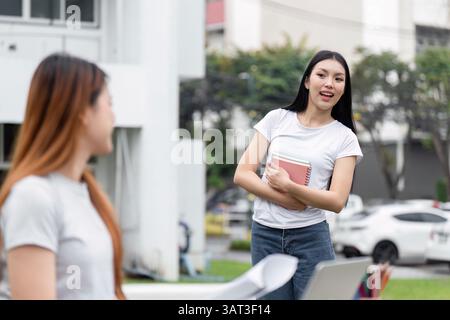 Friendship and Study Sessions. Two students discussing schoolwork outdoors, fostering a supportive learning environment. Stock Photo
