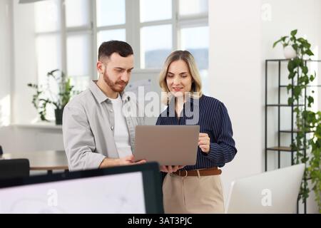 Engineers working together with laptop in office Stock Photo
