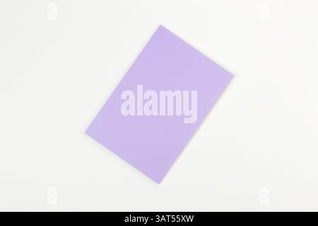 Top view of purple notebook on white background. School, office wallpaper. Flat lay, copy space. Stock Photo