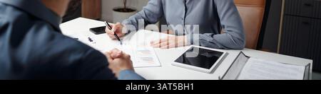 Smiling Woman Pointing at Data Report During Meeting Header Image Stock Photo