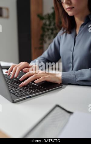 Woman Typing on Computer Keyboard in Office Stock Photo